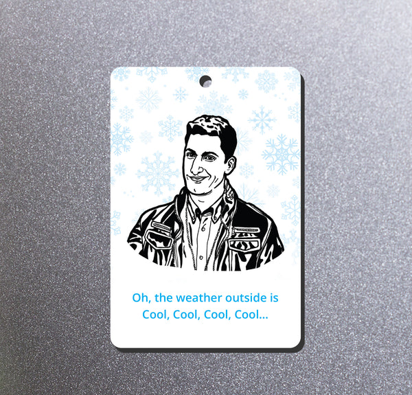 A magnet featuring a black-and-white illustrated portrait of Brooklyn Nine Nine's Jake Peralta, surrounded by light blue snowflakes and ending with the text 'Oh, the weather outside is Cool, Cool, Cool, Cool.'