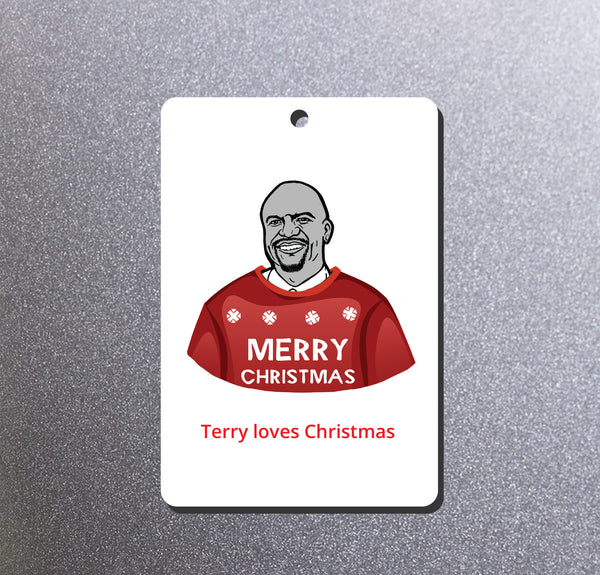 A magnet featuring an illustration of Brooklyn Nine Nine's Terry wearing a red sweater with snowflakes and the words 'MERRY CHRISTMAS'. Below the illustration, the text reads 'Terry loves Christmas'. The magnet is photographed against a textured gray background.