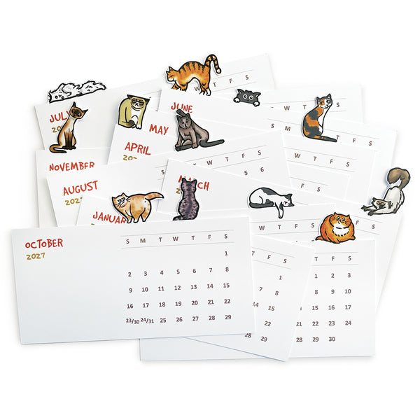 A variety of illustrated cats on the top of each die cut month on a desktop calendar shown as individual monthly cards.