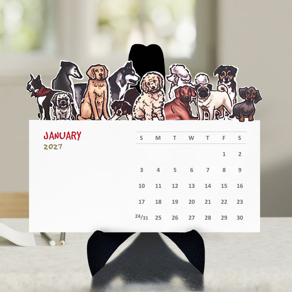 A variety of illustrated dogs on the top of each die cut month on a desktop calendar with a black easel sitting on a table.