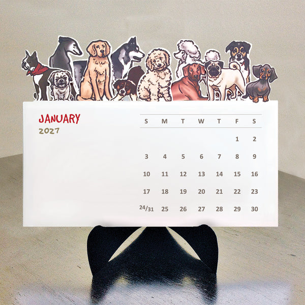 A variety of illustrated dogs on the top of each die cut month on a desktop calendar with a black easel sitting on a table.