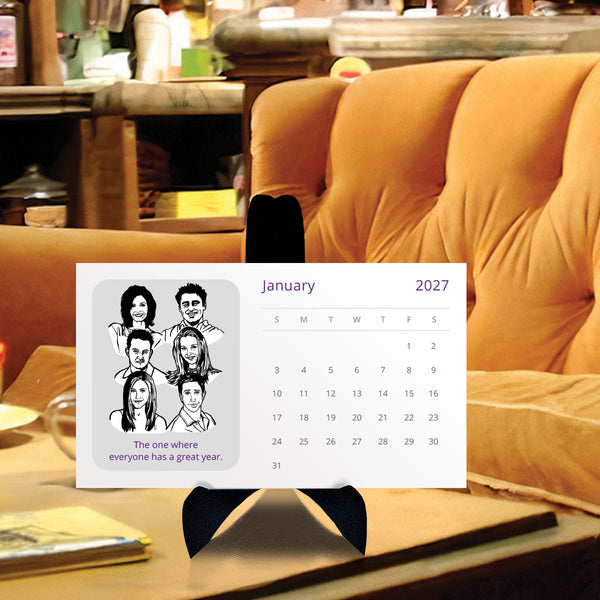 A desk calendar for 2027 featuring black and white illustrations of the Friends tv show characters on a black stand in the coffee shop central perk from the show.