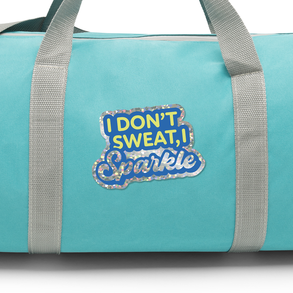 Turquoise duffel bag with gray straps and a Glitter vinyl die cut sticker with text 'I Don't Sweat, I Sparkle'.