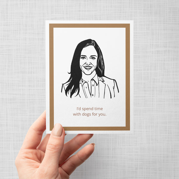 A hand holding a greeting card featuring an illustration of Brooklyn Nine Nine's Amy Santiago with text 'I'd spend time with dogs for you'