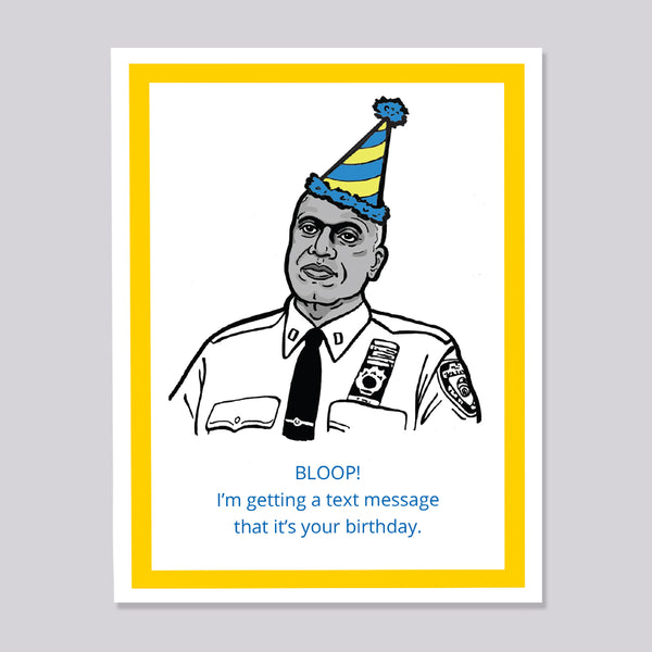 A novelty greeting card featuring an illustration of a Brooklyn Nine Nine's Captain Holt wearing a blue and yellow striped party hat. The card has a white background with a thick yellow border and blue text that reads, 'BLOOP! I'm getting a text message that it's your birthday.