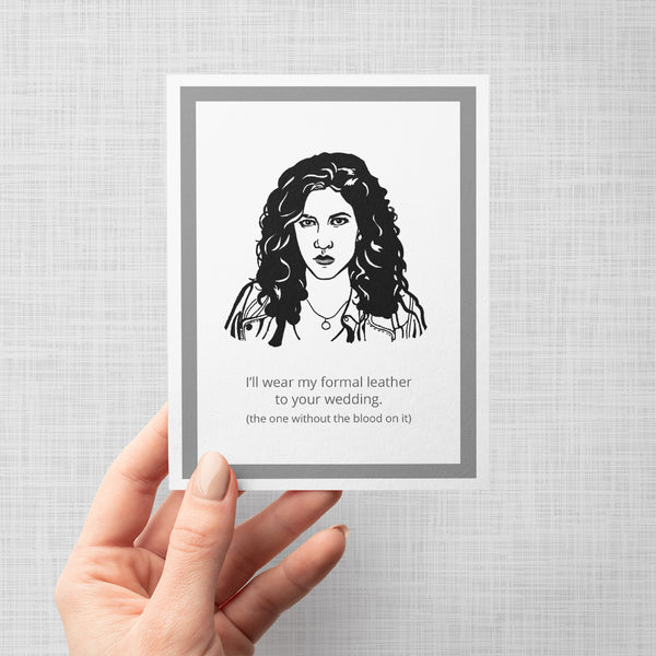 A hand holding a greeting card featuring a portrait of Brooklyn Nine Nine's Rosa with the quote, 'I'll wear my formal leather to your wedding. (the one without the blood on it)'.