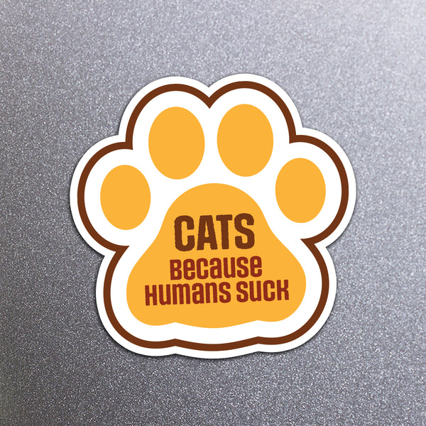 Magnet with a paw design and text 'CATS BECAUSE HUMANS SUCK' on a fridge background