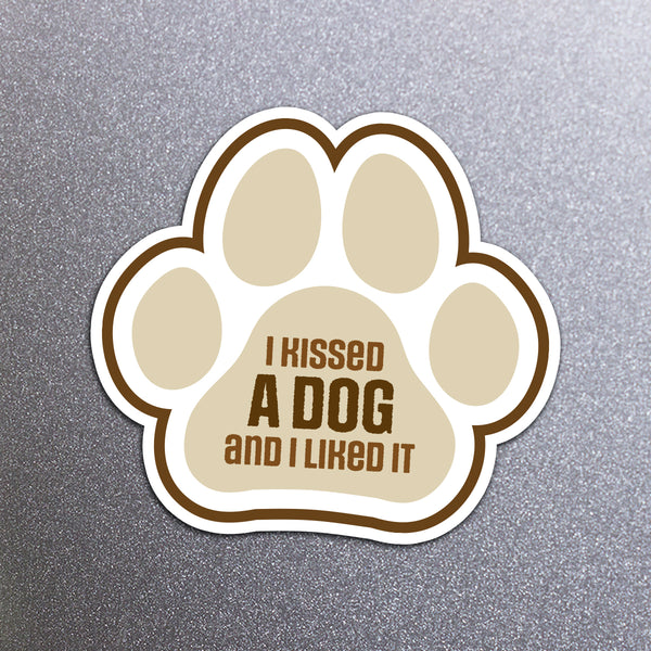 Paw-shaped magnet with 'I kissed a dog and I liked it' text on a fridge background