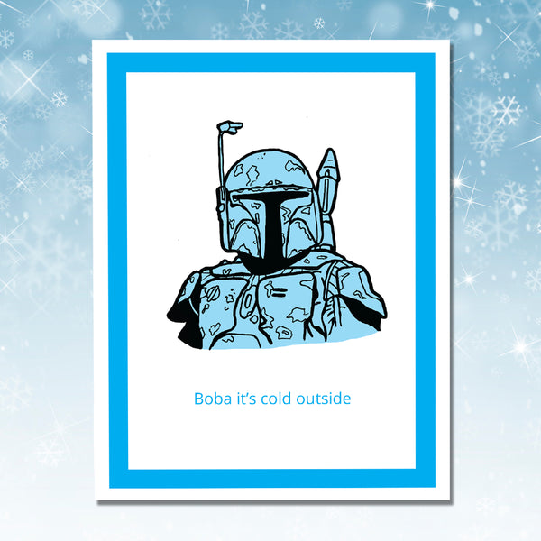 A greeting card featuring a stylized blue and black illustration of Boba Fett with the text 'Boba it's cold outside' below, set against a white background with a bright blue border, shown on a blue snowflake backdrop.