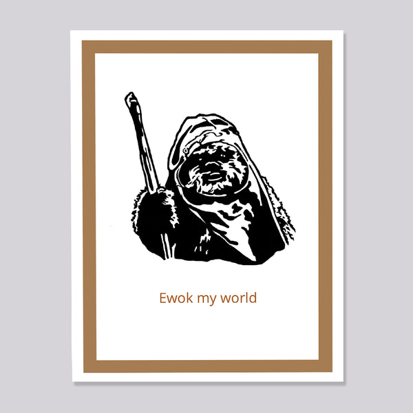 A greeting card featuring a black-and-white illustration of a Star Wars Ewok holding a staff, with the text 'Ewok my world' in brown below. The print has a white center and a tan inner border shown against a neutral light gray background.