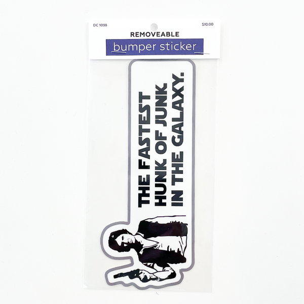 A packaged bumper sticker on a white background. The sticker has an illustration of Star Wars Han Solo with black text reading 'THE FASTEST HUNK OF JUNK IN THE GALAXY.