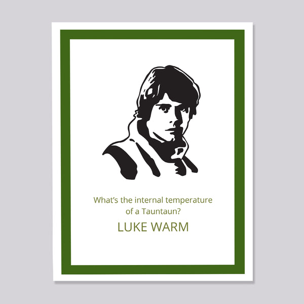A greeting card featuring a black and white graphic portrait of Luke Skywalker with green text reading 'What's the internal temperature of a Tauntaun? LUKE WARM'. The card has a white border and is framed by a dark green inner border and a light gray outer background.