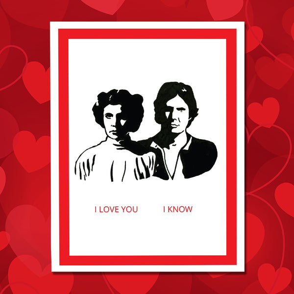 A greeting card featuring a black-and-white illustration of Princess Leia and Han Solo, with red border and the text 'I LOVE YOU I KNOW' in red at the bottom, shown against a red hearts background.