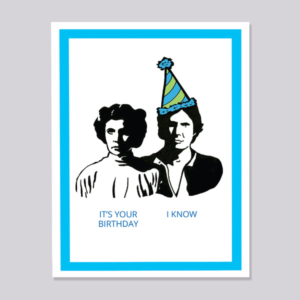 Greeting card with black and white illustrations of Princess Leia and Han Solo wearing party hats, text 'It's your birthday' and 'I know', on a gray background.