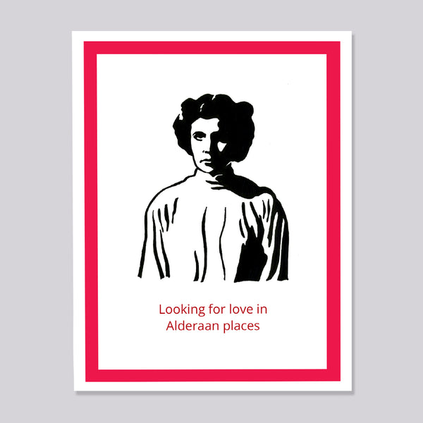 A greeting card featuring a black and white illustration of Princess Leia, bordered by a red frame, with the red text 'Looking for love in Alderaan places' at the bottom, shown against a neutral gray background.
