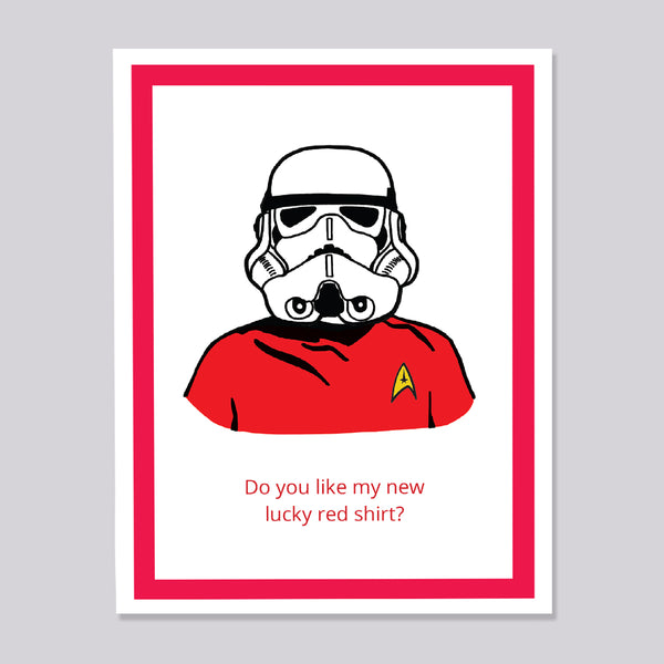 A greeting card featuring a stylized illustration of a Star Wars stormtrooper wearing a red Star Trek uniform shirt with a yellow delta insignia. Below the illustration, the text reads 'Do you like my new lucky red shirt?'.