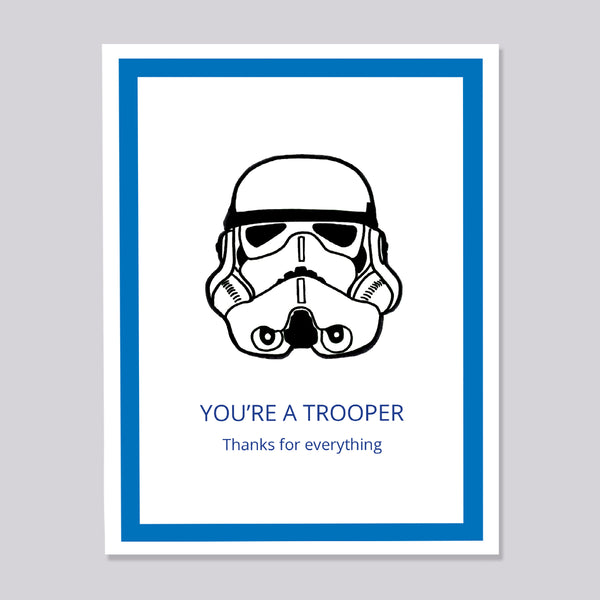 A greeting card featuring a black line art illustration of a Star Wars stormtrooper helmet on a white background, framed by a blue border. Below the illustration, the text reads 'YOU'RE A TROOPER' and 'Thanks for everything' in blue.
