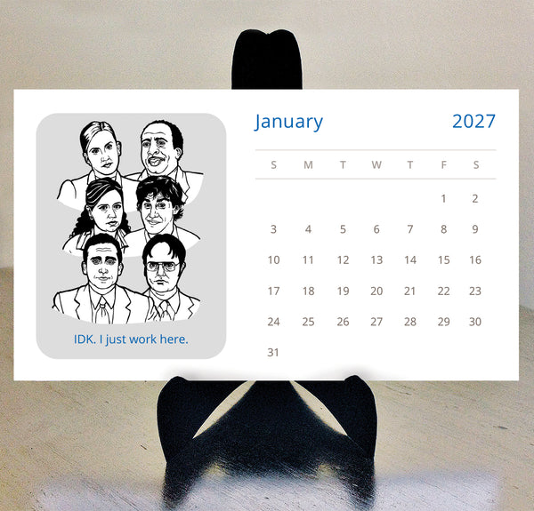 A 2027 desk calendar card featuring black-and-white illustrated portraits of characters from The Office tv show and the text 'IDK. I just work here.