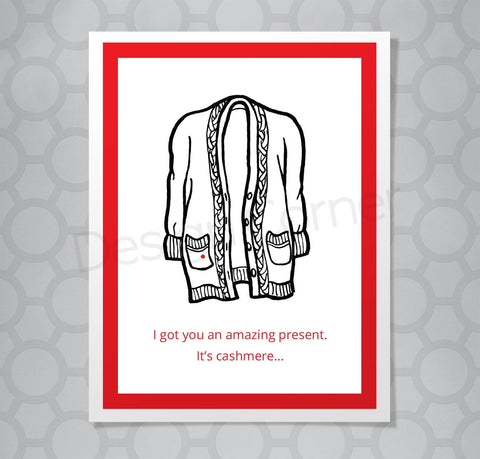 Christmas card with illustration of Seinfeld cashmere sweater with small red dot on it. Caption says "I got you an amazing present. It's cashmere...