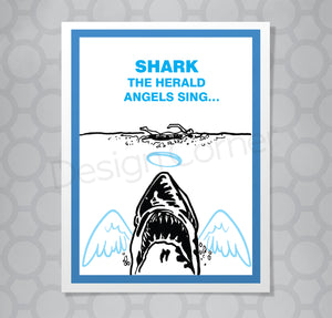 Illustration of Jaws shark from movie on greeting card with caption "Shark the herald angels sing. Shark has angel wings and a halo.